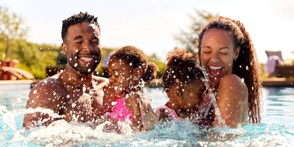 A family splashes in a pool.